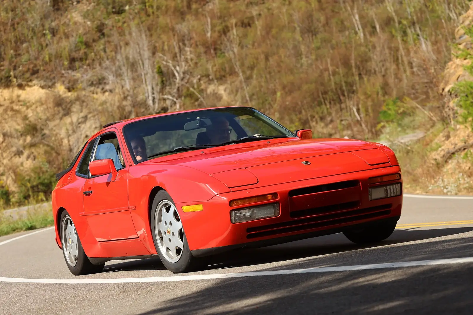A red 944 S2 mid-corner on the Dragon
