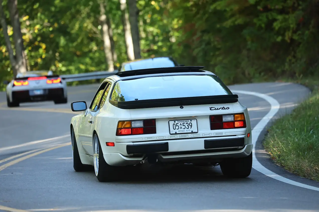 A white 944 Turbo heading into a string of switchbacks on the Dragon
