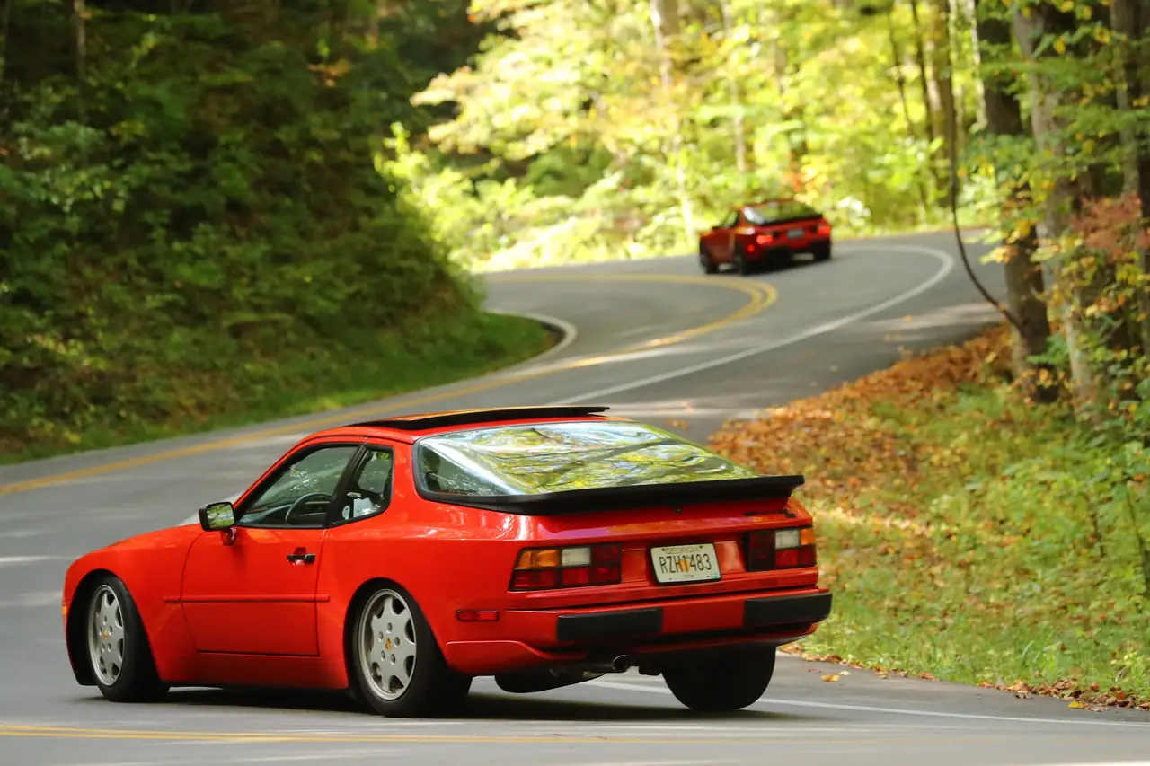 A red 944 heading away down a winding mountain road